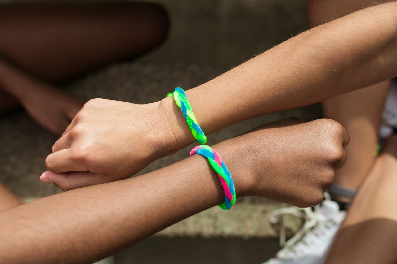 pexels photo 8035134 8035134 Two wrists with colorful friendship bracelets in a close-up view, symbolizing friendship.